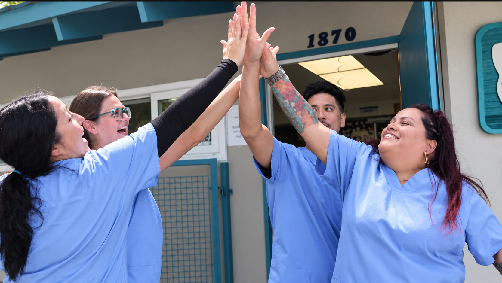 Academy students and instructors celebrating together outside the clinic